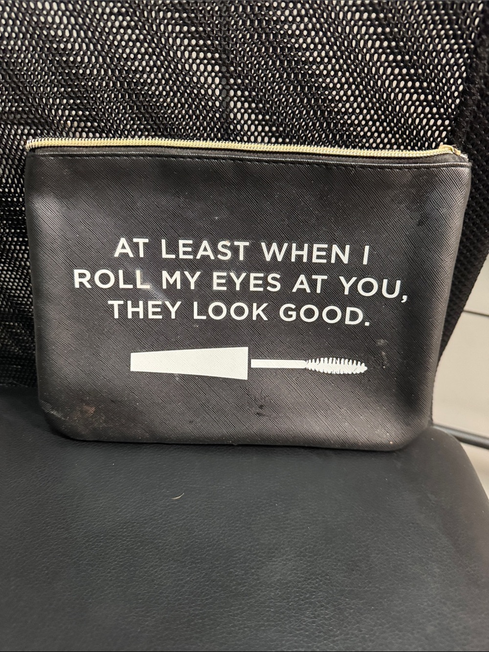 Black Cosmetic case says  AT LEAST WHEN I ROLL MY EYES AT YOU, THEY LOOK GOOD.